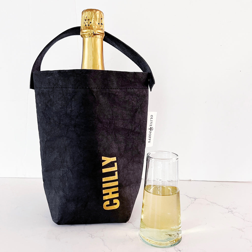 A black wine bag that is insulated and waterproof, so you can fill with ice and chill your bottles. It had a black vegan leather handle and the word "chilly" screen printed in gold on the bag.